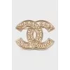 Golden decorated logo brooch