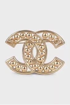 Golden decorated logo brooch