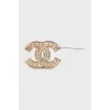 Golden decorated logo brooch
