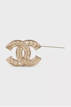 Golden decorated logo brooch