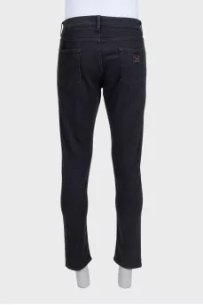 Men's black tapered fit jeans with buttons