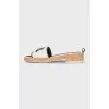 Black and white flip flops with a patch