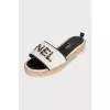 Black and white flip flops with a patch