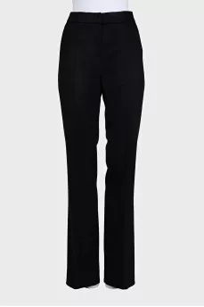 A suit consisting of a fitted jacket and straight trousers