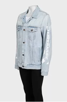Blue denim jacket with a signature print
