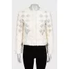 Straight jacket decorated with perforations