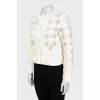 Straight jacket decorated with perforations