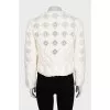 Straight jacket decorated with perforations