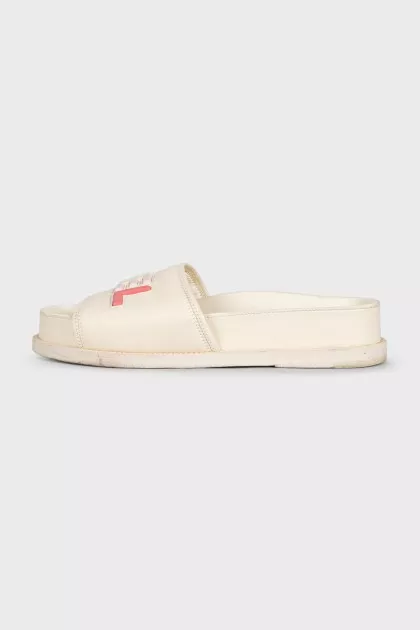 White leather flip-flops with a multi-colored logo