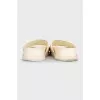 White leather flip-flops with a multi-colored logo