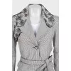 A checkered suit decorated with embroidered frills