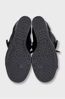Black leather sneakers with gold hardware