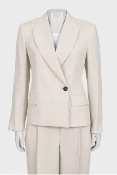 A suit consisting of a button-down jacket and trousers with a tag