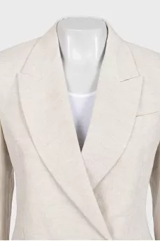 A suit consisting of a button-down jacket and trousers with a tag