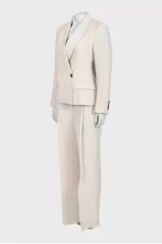 A suit consisting of a button-down jacket and trousers with a tag