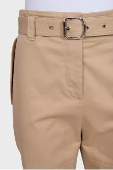Tapered beige trousers with a belt