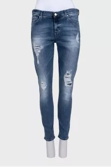 Mid-rise blue jeans with a distressed effect