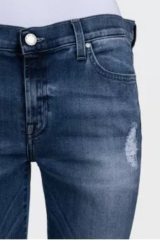 Mid-rise blue jeans with a distressed effect