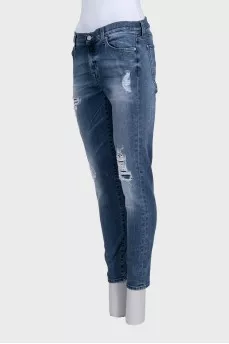 Mid-rise blue jeans with a distressed effect