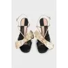 Leather sandals with a gold bow