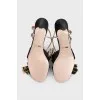Leather sandals with a gold bow