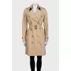Beige trench coat with leather buckles