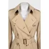 Beige trench coat with leather buckles
