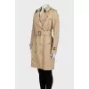 Beige trench coat with leather buckles