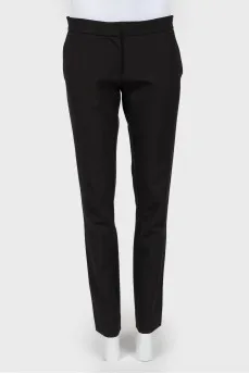 Black trousers of a straight cut on a zipper