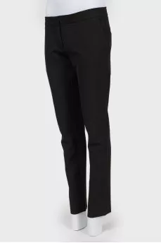 Black trousers of a straight cut on a zipper