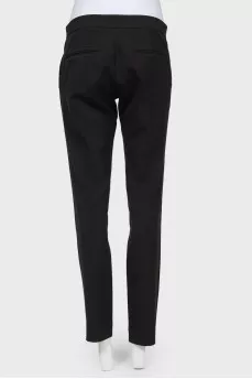 Black trousers of a straight cut on a zipper