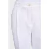 White tapered trousers with a zipper