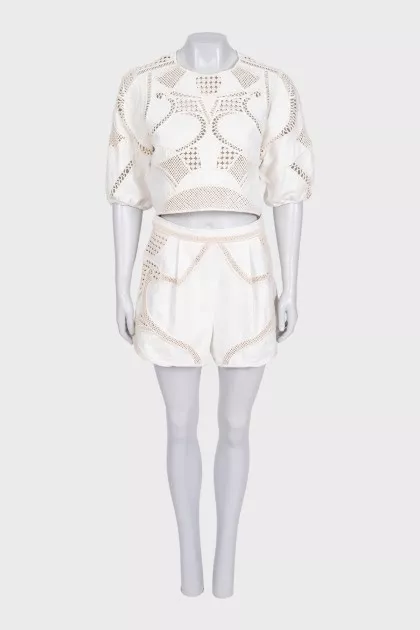 Beige suit with shorts decorated with perforations