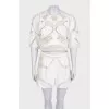 Beige suit with shorts decorated with perforations