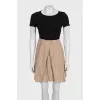 Black fitted dress with beige hem