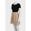 Black fitted dress with beige hem