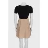 Black fitted dress with beige hem