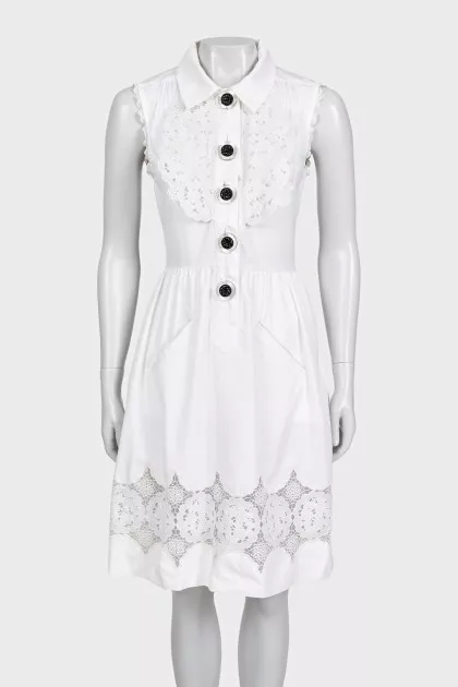 White fitted dress decorated with perforations