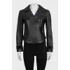 Black leather jacket with textile inserts on the sleeves