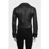 Black leather jacket with textile inserts on the sleeves