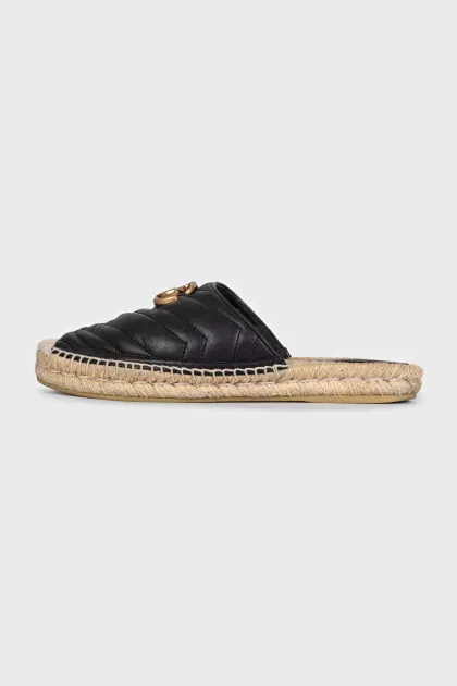 Black mules with a metallic logo