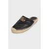 Black mules with a metallic logo