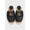 Black mules with a metallic logo
