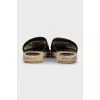 Black mules with a metallic logo