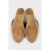 Black mules with a metallic logo