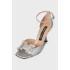 Shiny sandals with a figured heel