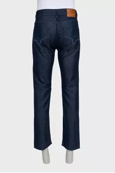 Men's dark blue jeans with embroidery on the pockets