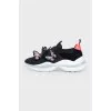 Black sneakers decorated with butterflies
