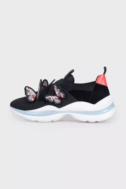 Black sneakers decorated with butterflies