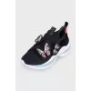 Black sneakers decorated with butterflies